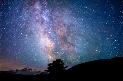 silhouette of trees and mountain under blue sky at nighttime amazing zoom background