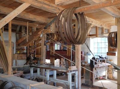 brown belts hanged in brown wooden post inside building