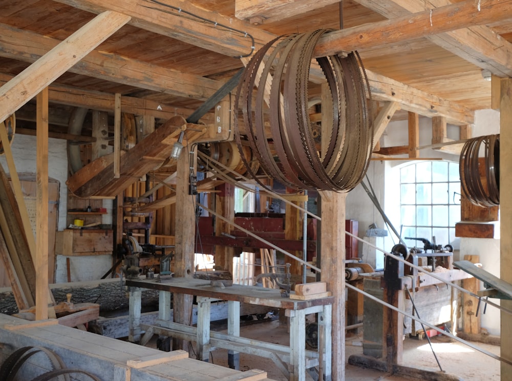 brown belts hanged in brown wooden post inside building