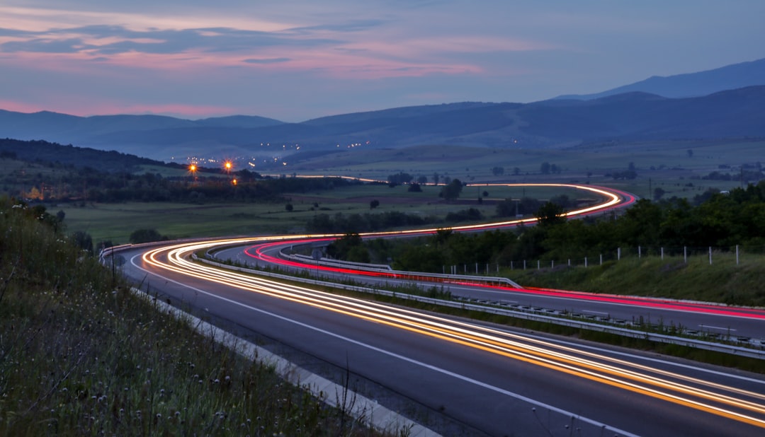 time lapsed photography of asphalt road, Car light trails on a winding highway