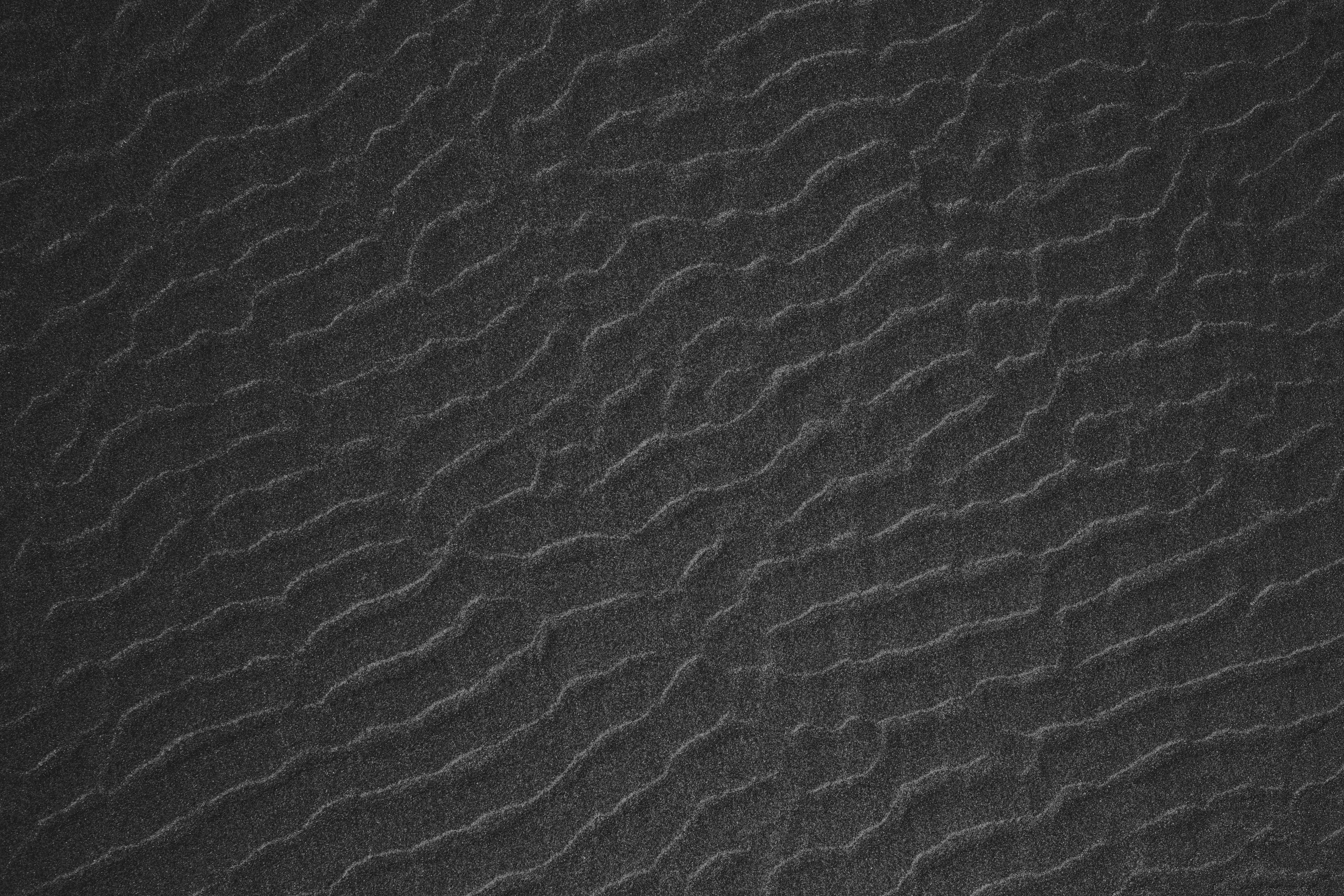 A lone goat standing on a rugged cliff