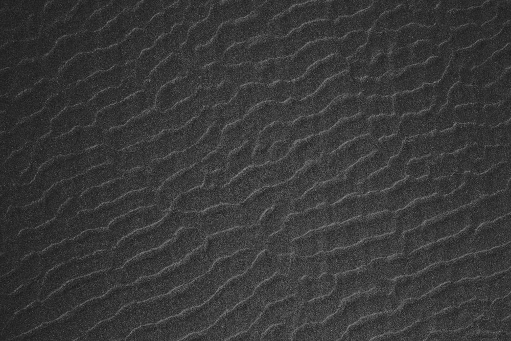 a black and white photo of a textured surface