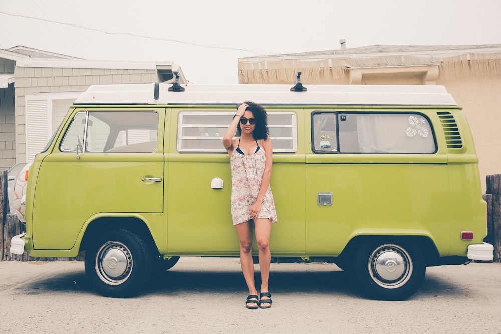 woman leaning on green bus