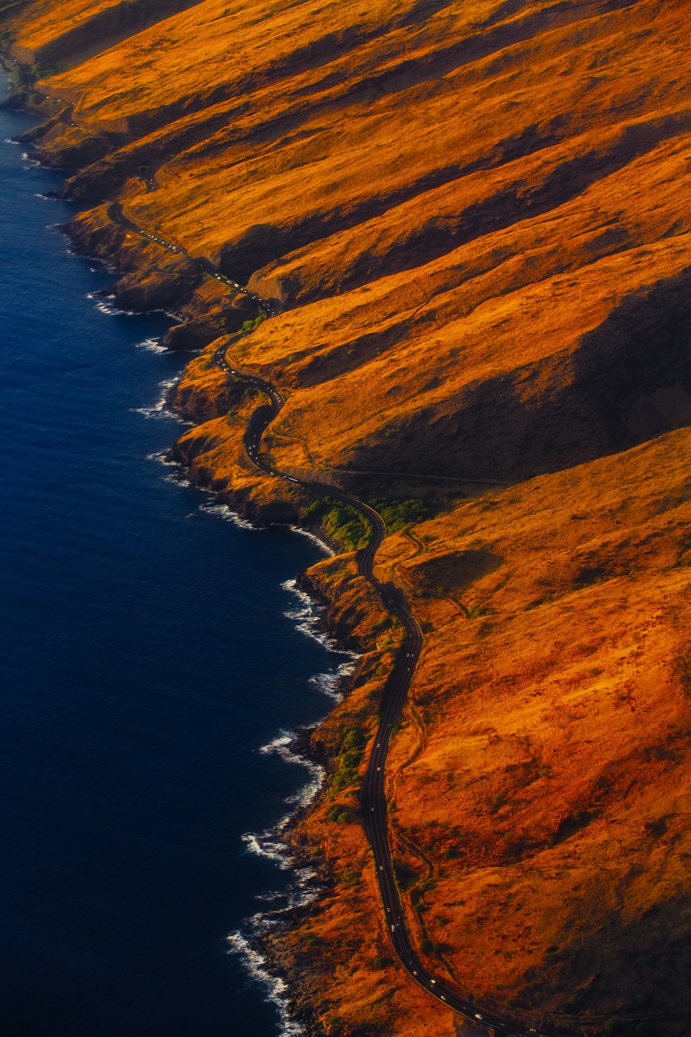 Fotografía aérea de la carretera en la montaña cerca de la orilla del mar