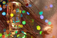 A delicate glass vial filled with sparkling peptide crystals resting on a wooden surface.