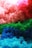 A vibrant array of colorful tulle fabric is layered in shades of red, pink, green, and blue, creating a textured and fluffy appearance.