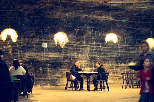 A cozy, dimly lit underground supper club filled with intimate tables and warm lighting.