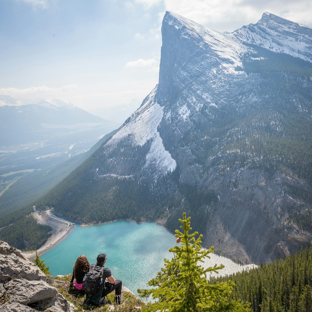 couple at the peak facing mountain