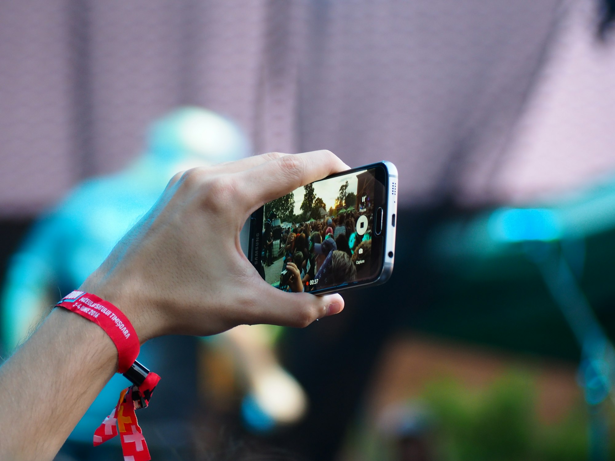 person using a smartphone to record video in 2023