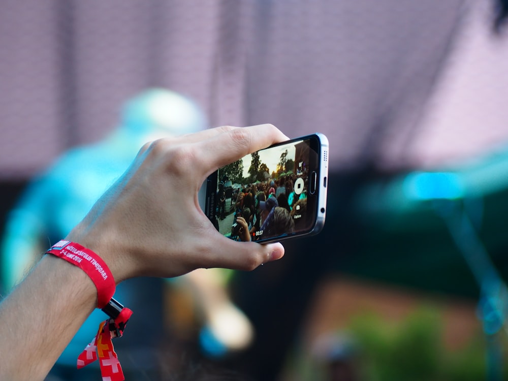 person using black smartphone