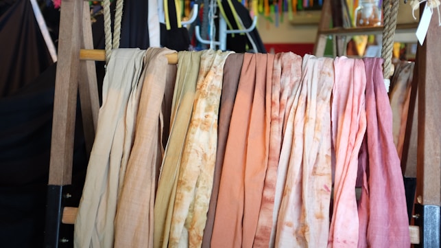 assorted scarves on brown wooden rack