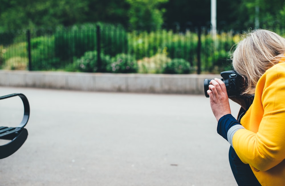 woman taking photo of vehicle