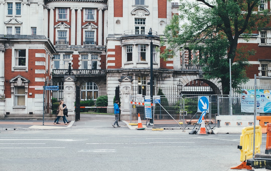 people walking near white and red building