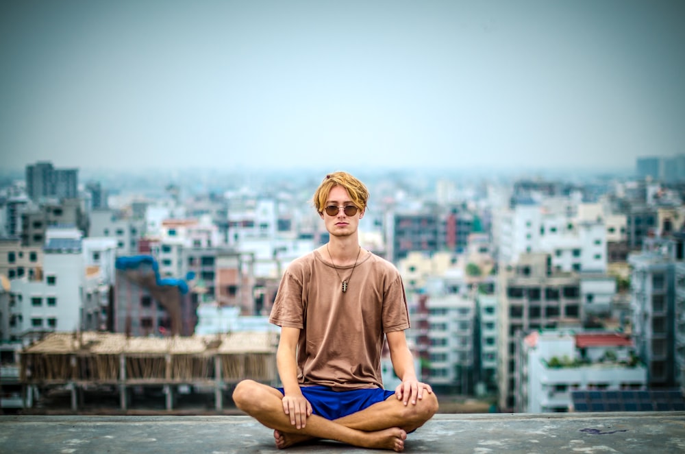 man sitting at the top of the building