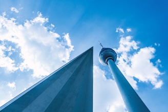 A close-up of a finished triangle tower against a clear blue sky.