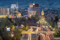 A cinematic video frame showing a bustling street scene in downtown Sacramento at dusk.