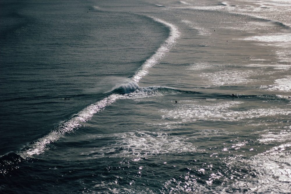 a person riding a surfboard on top of a wave in the ocean