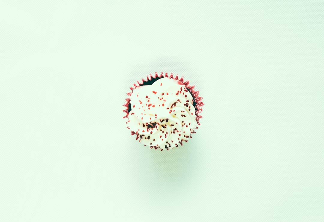 shallow focus photo of white cupcake