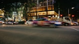 A busy road scene with vehicles in motion.