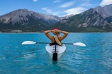 woman riding kayak at the middle of the sea