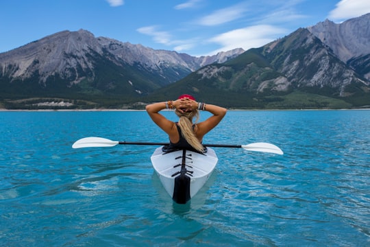 woman riding kayak at the middle of the sea in Nordegg Canada