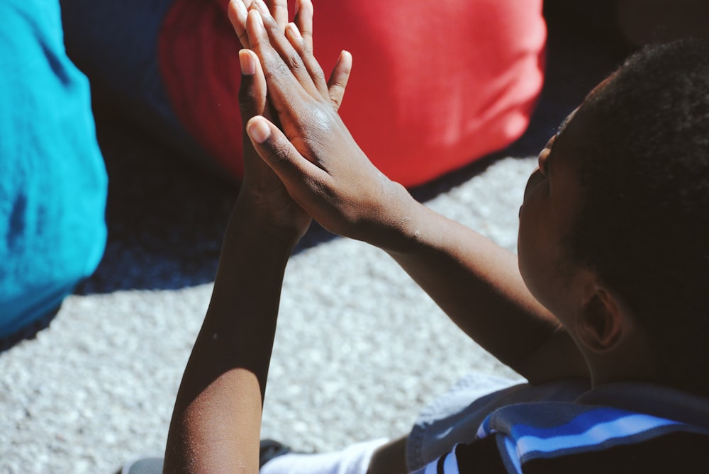 man clapping his hand during daytime