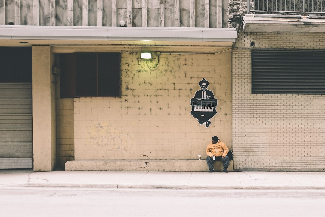 person sitting on gray concrete bench