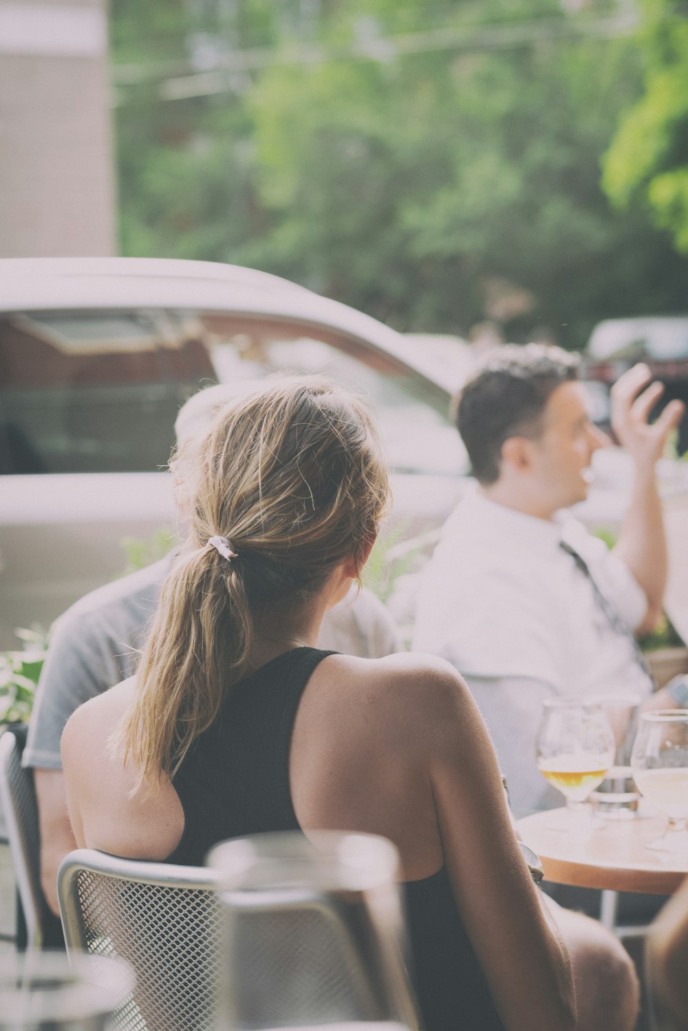 people sitting near table viewing vehicle