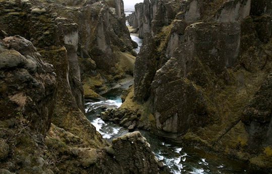 rocky terrain with river in middle in Fjaðrárgljúfur Iceland
