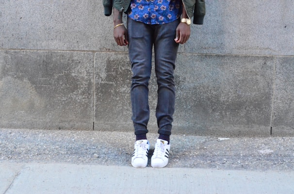 Model wearing a Timetraps jacket standing against a city wall.