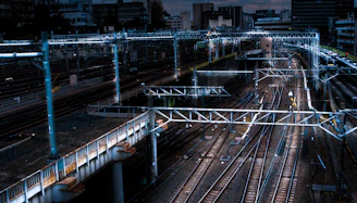 An aerial view of a sprawling, complex metro network under construction at dusk.