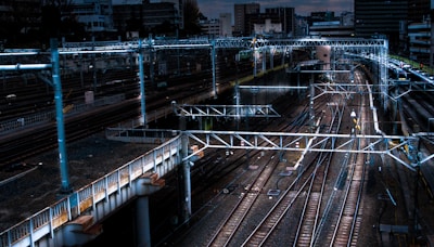 blue lighted bridge near railways