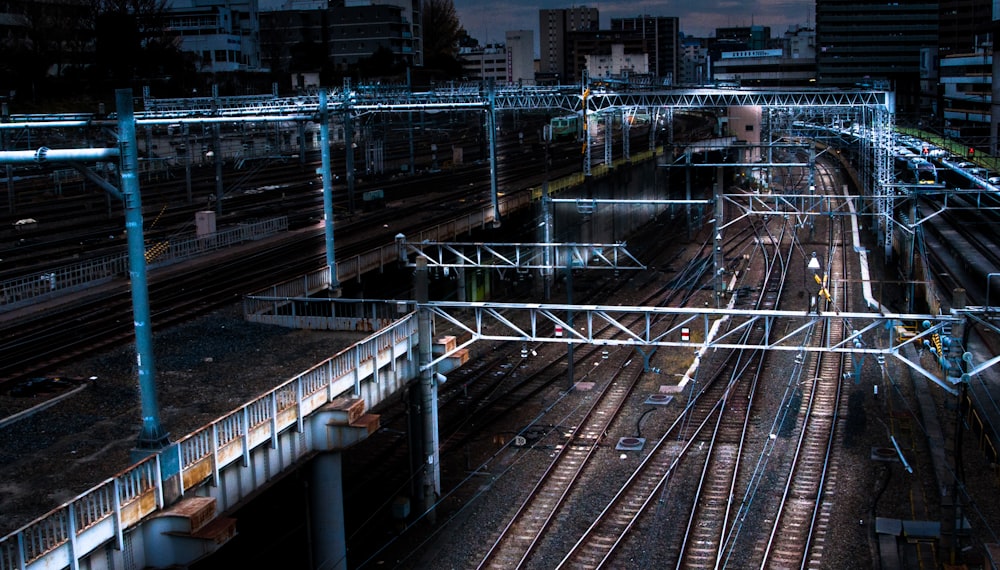 blue lighted bridge near railways