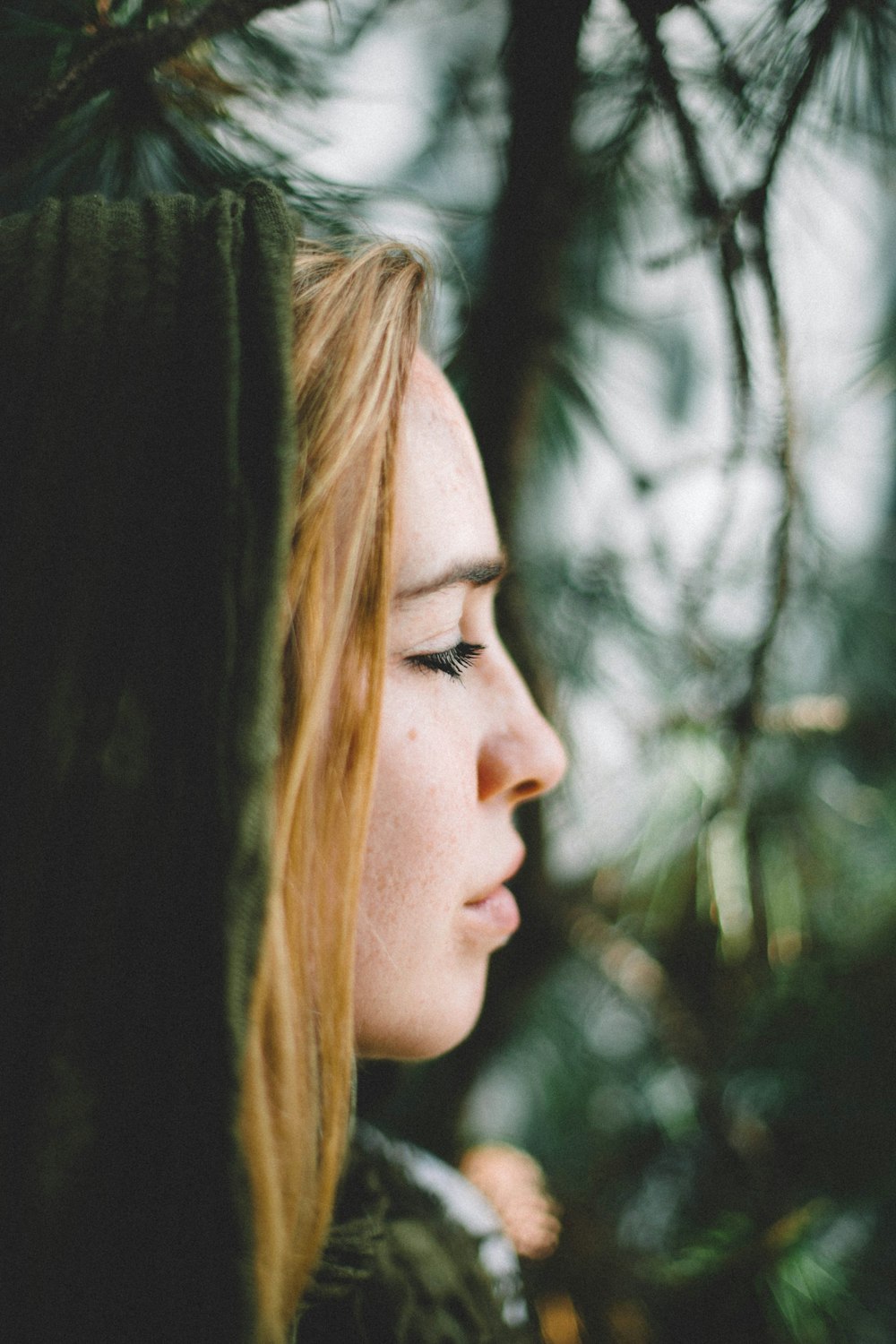 selective focus photography of woman with green hood