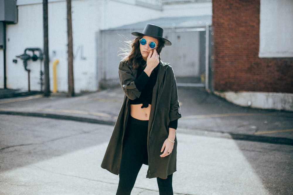 woman standing behind white and brown concrete wall