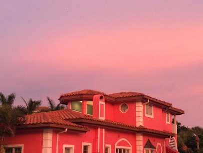 A sunny Arizona home mid-way through an exterior paint job with vibrant colors.