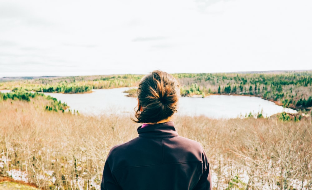 woman facing body of water