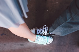 person wearing teal and white Converse All-Star low-top