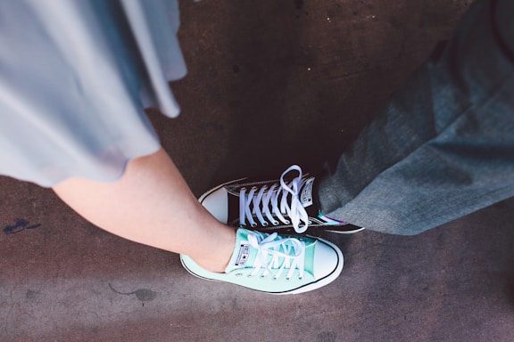 person wearing teal and white Converse All-Star low-top