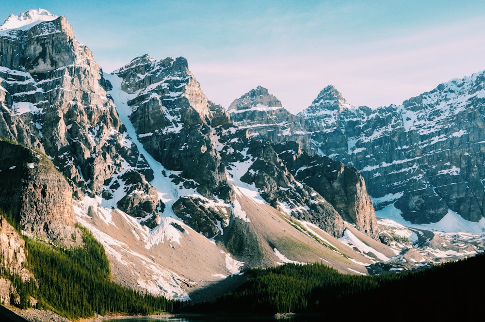 brown mountain filled with snow during daytime