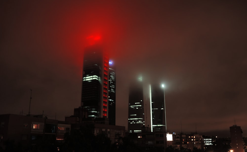 a red light shines in the night sky over a city
