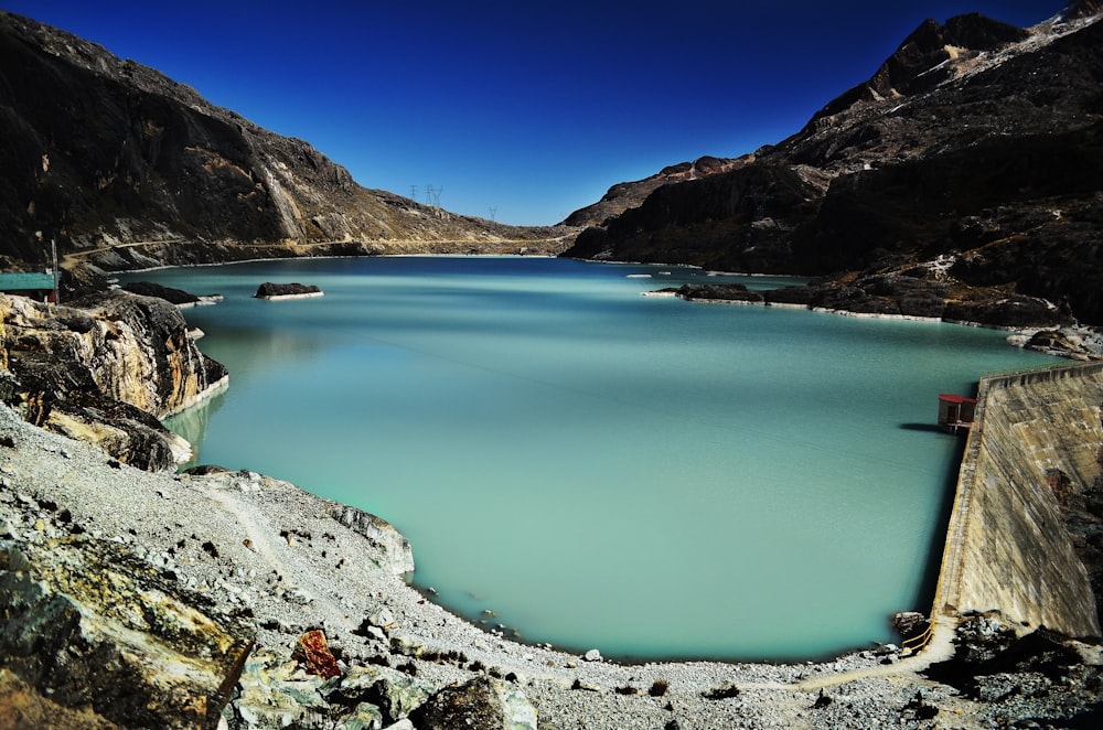 dam within mountain range during daytime