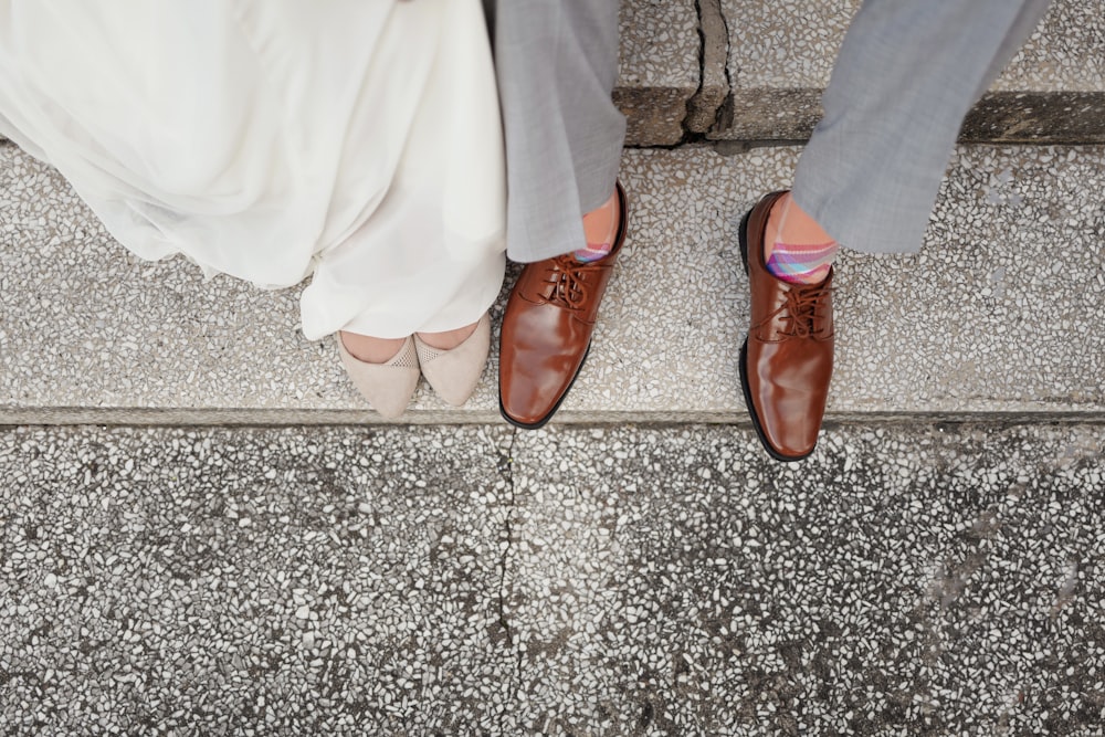 person wearing pair of brown leather dress shoes