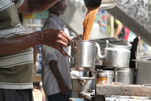 A tea stall setup with jars of jaggery and fresh tea leaves ready for brewing.
