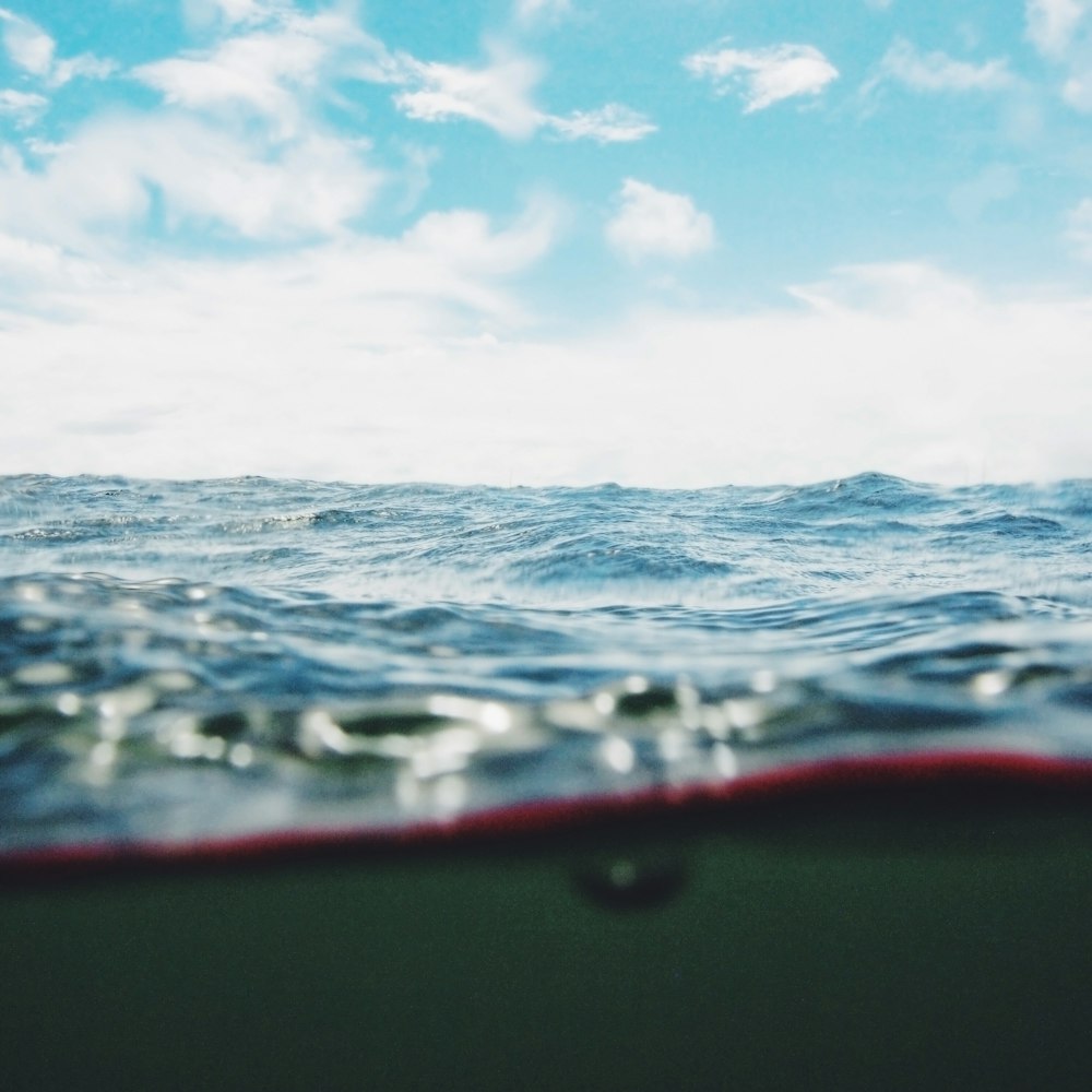 body of water under cloudy sky