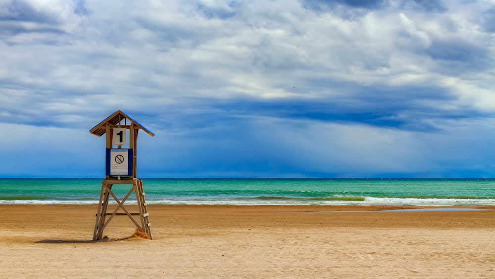 photo of lifeguard house on seashore during daytime