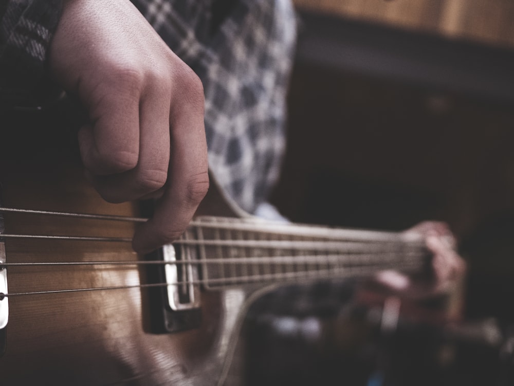 person playing acoustic guitar