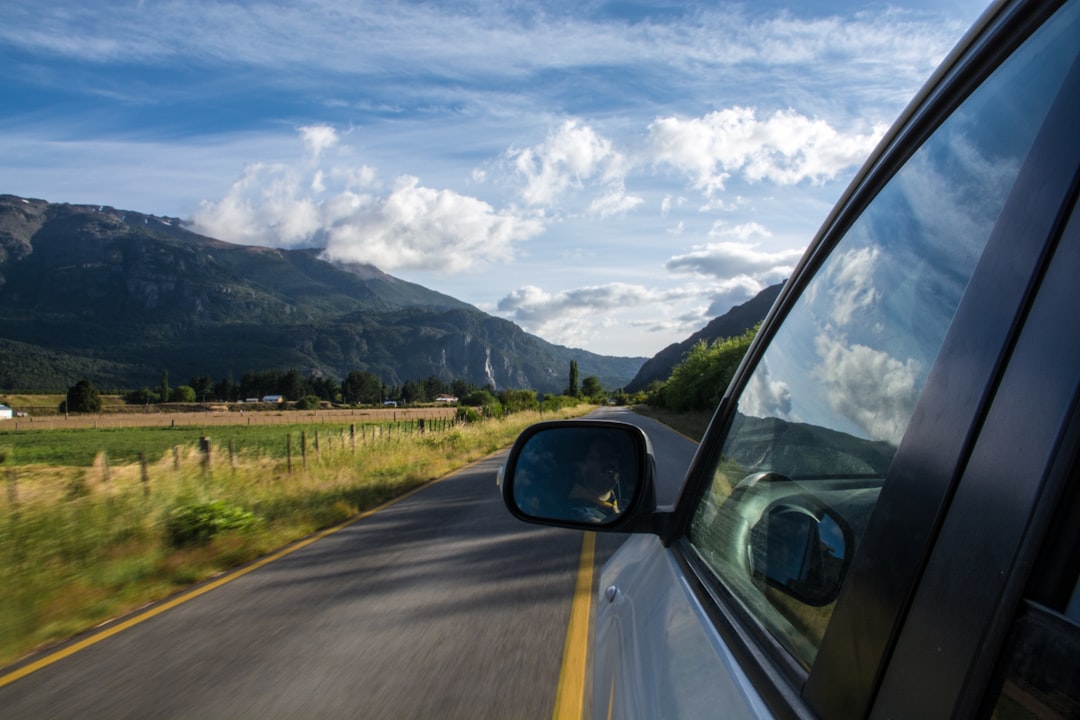 car on empty asphalt road, Road trip in the mountainous countryside