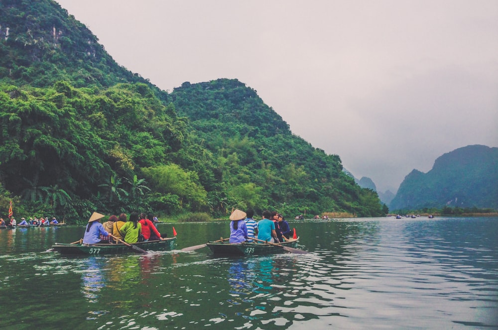 a group of people riding on top of a boat on a river