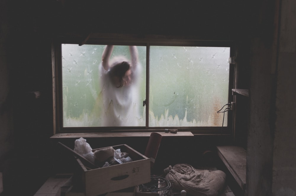 woman leaning on window